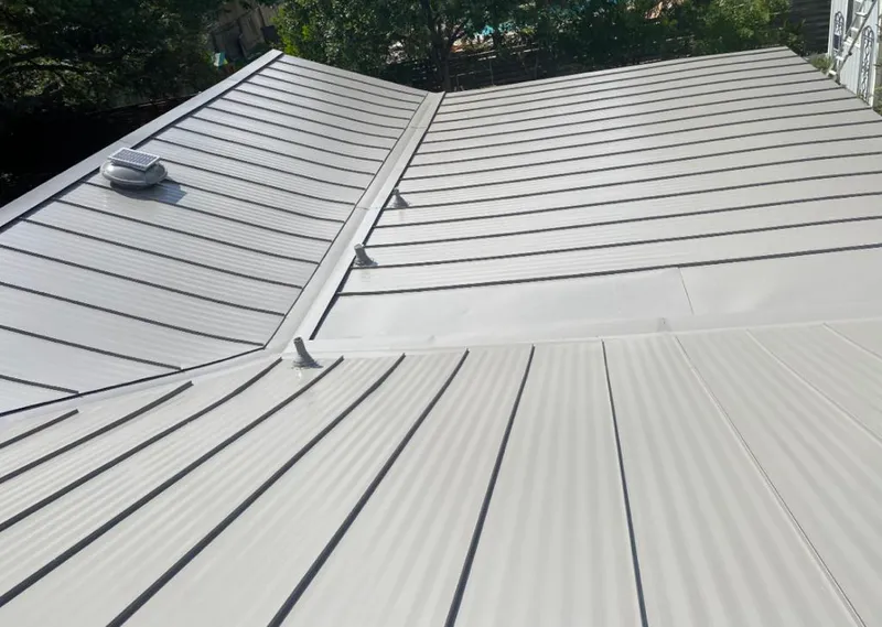 Solar attic fan installed on a metal roof for Roof Ventilation in White House